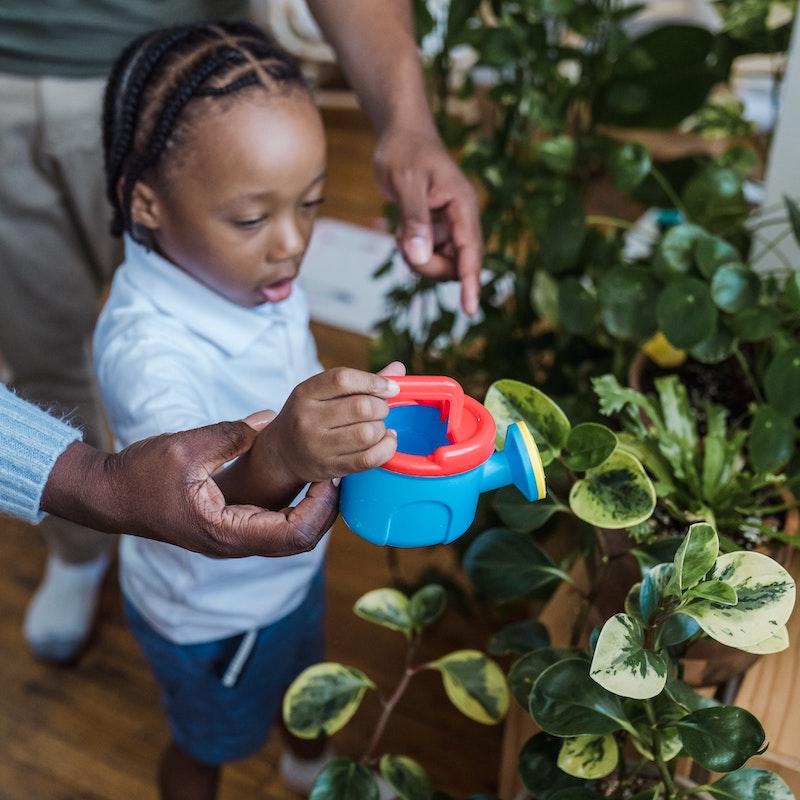 child watering plants